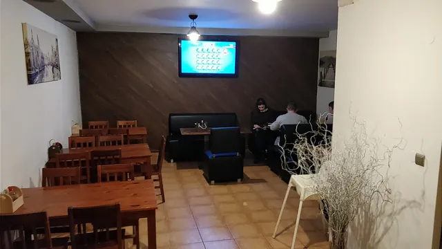 Interiér reštaurácie, barová časť s drevenými stolmi